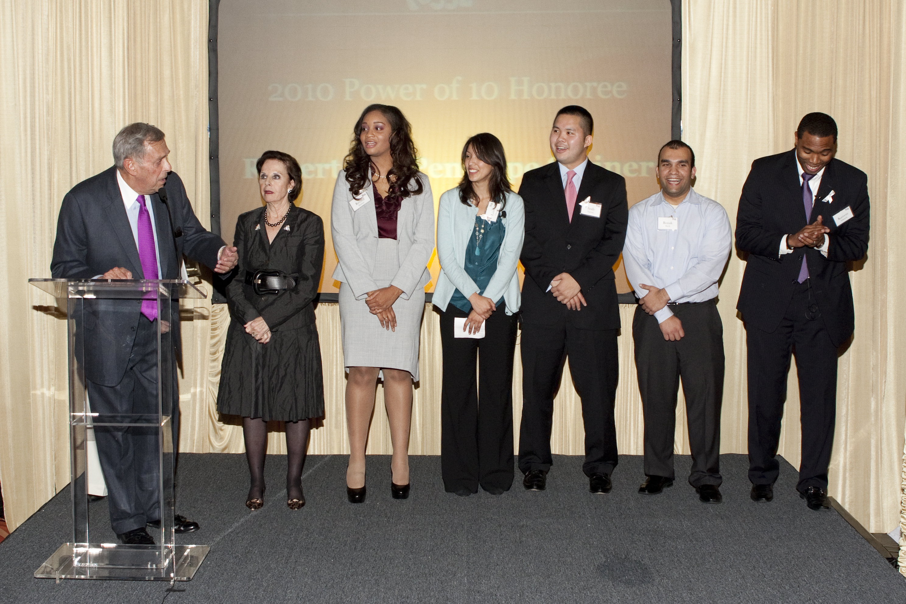 Bob and Penelope Steiner (left) were honored at Posse Chicago's Power of 10 event in 2010. They took the stage with Posse Scholars and alumni, including Andy Nguyen (3rd from right).