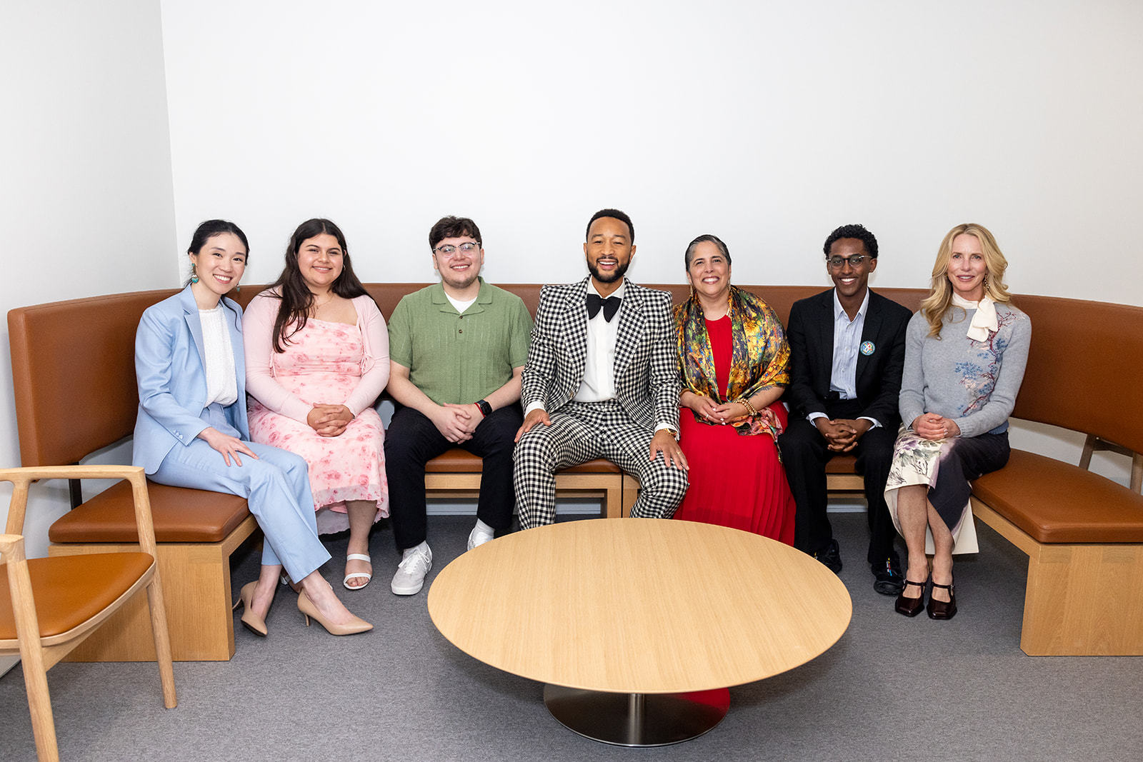 People in fancy attire sitting.