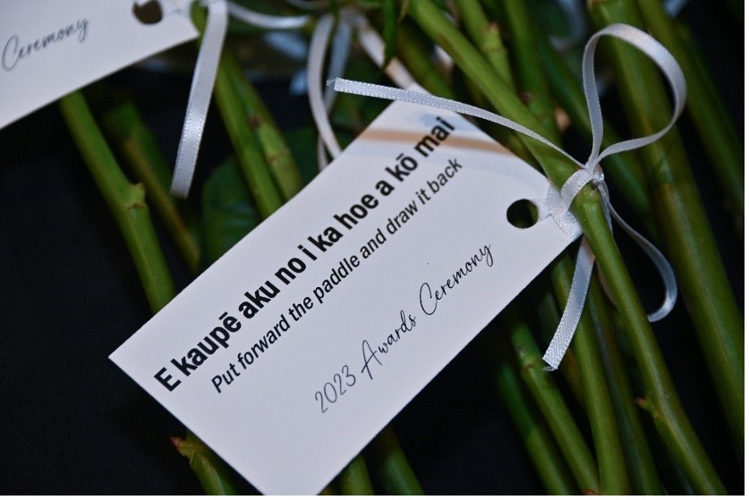 Note tied to the stem of a rose. 