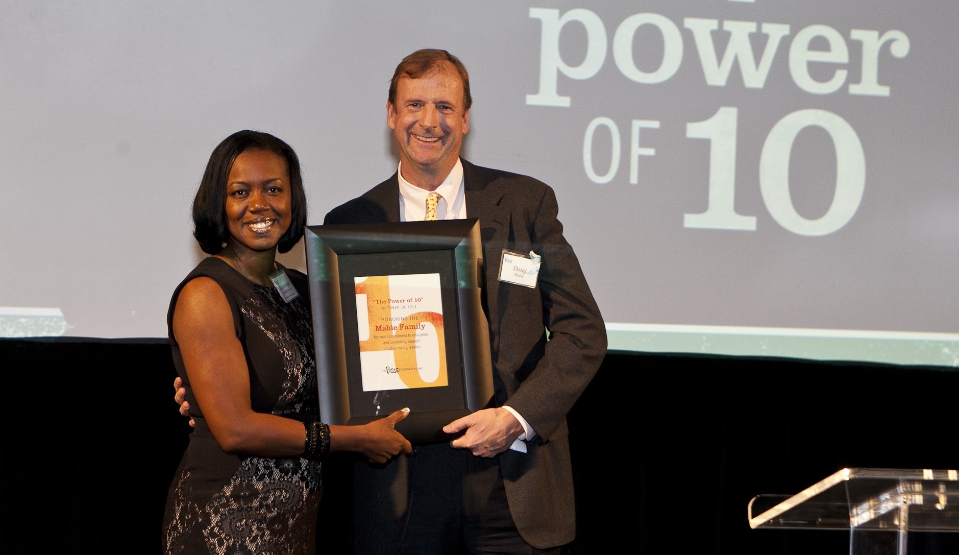 Doug Mabie accepts an award on behalf of his family as they are honored by Posse Chicago Director Dominique Jordan-Turner.