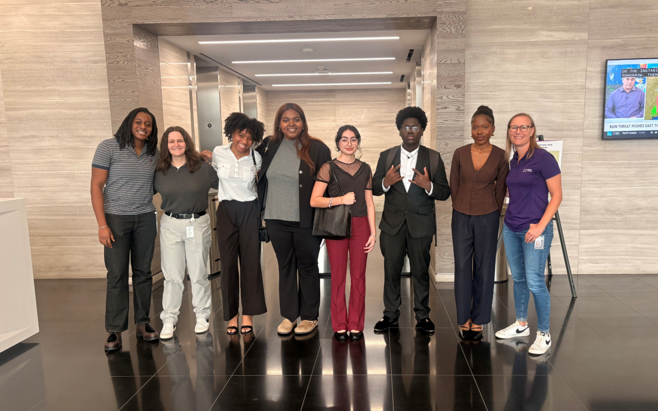 people in business attire in front of elevator bank. 