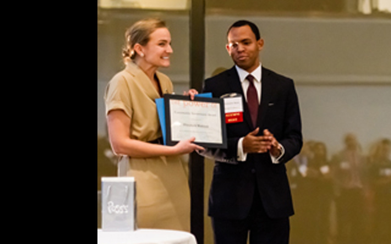 Christopher Moore (Denison Posse 3) presents Elizabeth Walczak (Hamilton Posse 1) with the Community Investment Award.