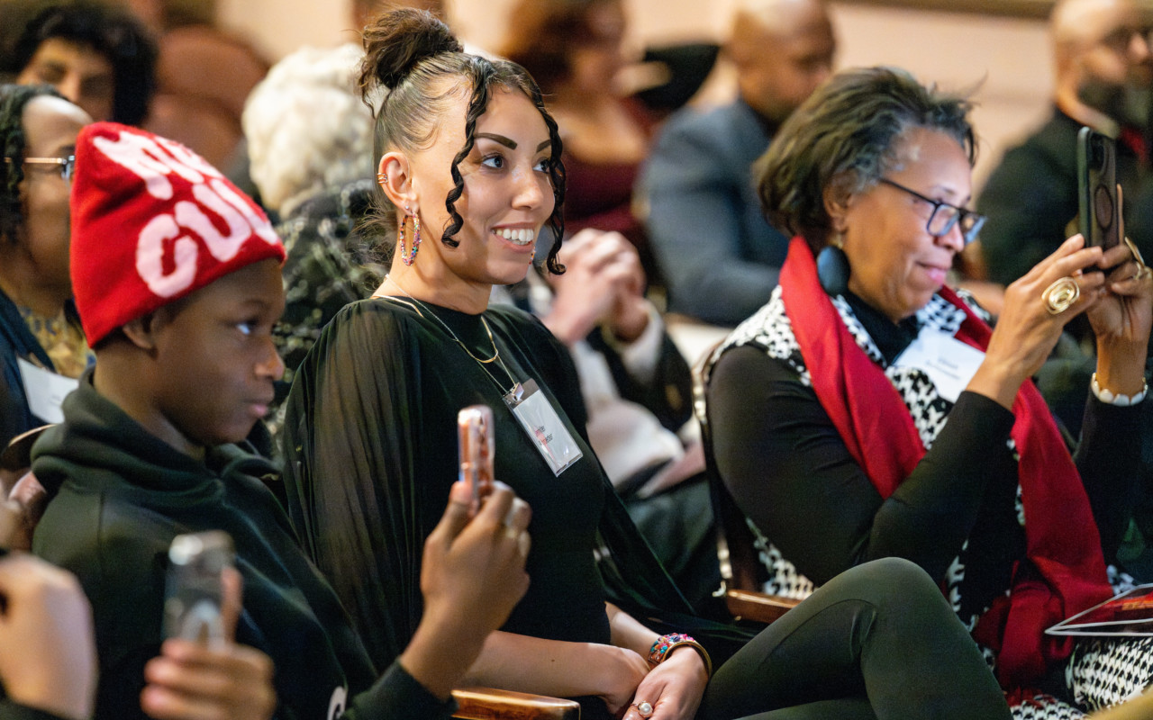 woman wears black, smiling.
