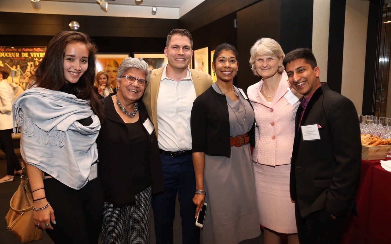 Patrick DeYoung (center) with fellow leaders of the Vassar Refugee Solidarity, Professor Höhn (second from left) and Vassar President Elizabeth Bradley (second from right).