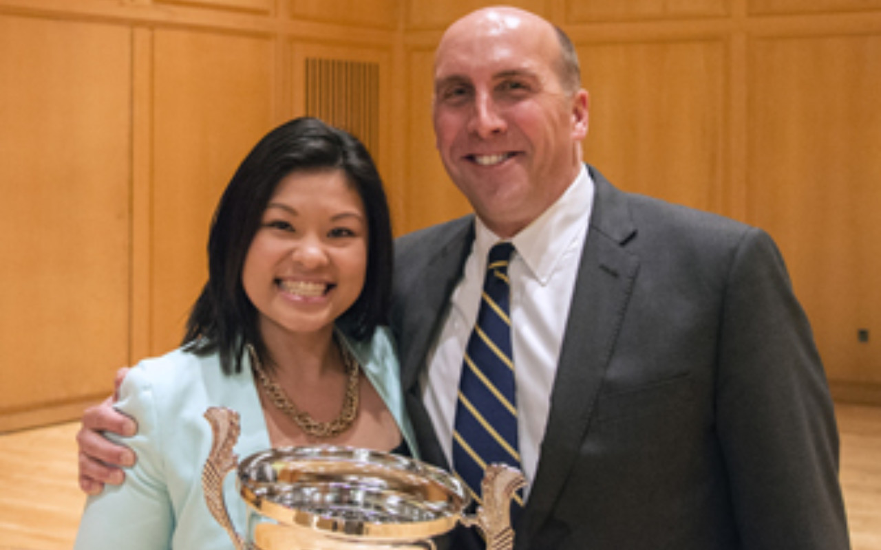 Sandy Tran with the DePauw University Walker Cup and DePauw President Brian W. Casey.