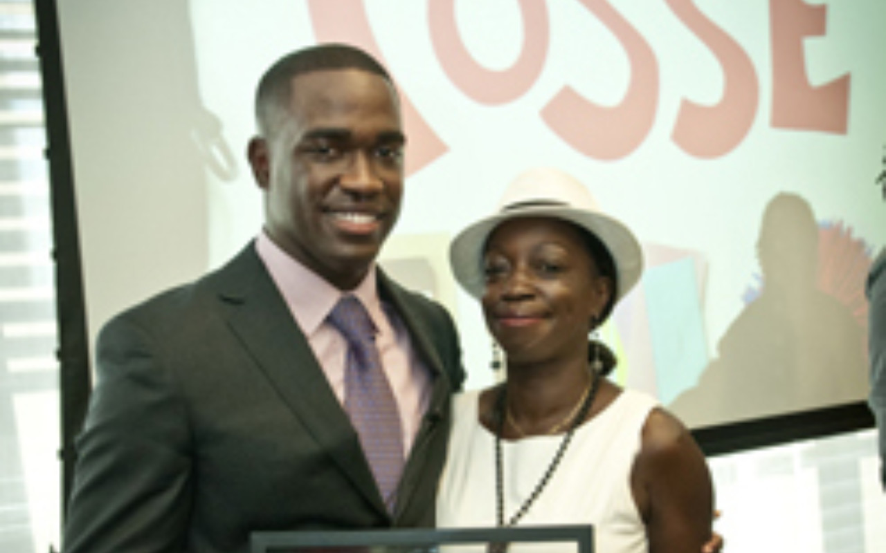 Captain Carmen Green Jr. (Trinity Posse 1, New York) accepts the 2012 Ainslie Alumni Achievement Award with his mother.