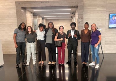 people in business attire in front of elevator bank. 