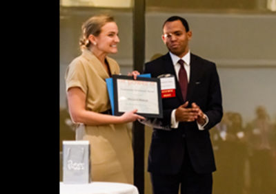 Christopher Moore (Denison Posse 3) presents Elizabeth Walczak (Hamilton Posse 1) with the Community Investment Award.