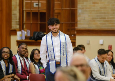a man wearing a white shirt and smiling.
