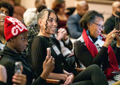 woman wears black, smiling.