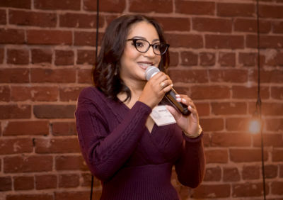 Woman Speaking into microphone